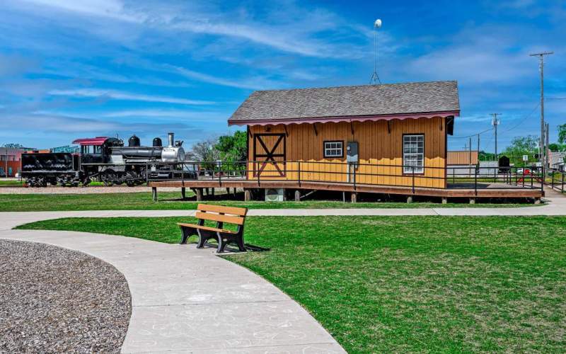 Park bench next to train depot in Anna TX