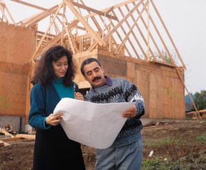 Buyer and builder in Princeton homes for sale, looking at plans for new construction