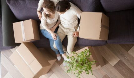 Newlyweds buying a home and moving boxes