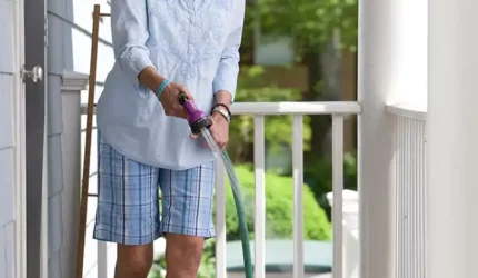 Lady cleaning the front porch for spring de-winterizing