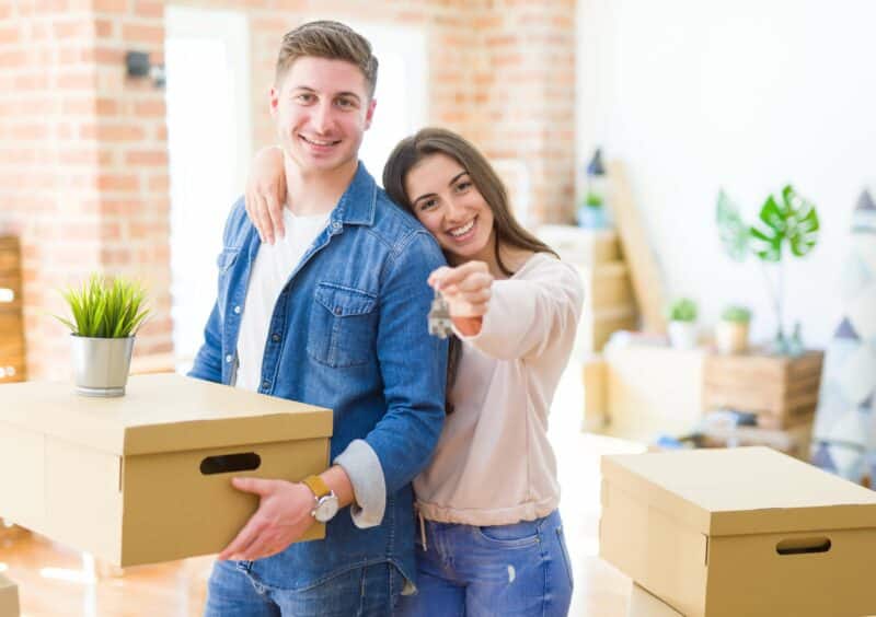 Happy couple moving boxes