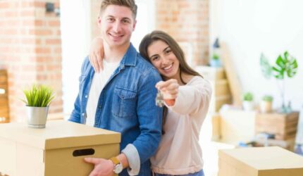 Happy couple moving boxes