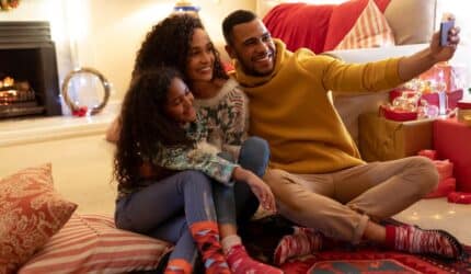 Family taking holiday photo in their new home