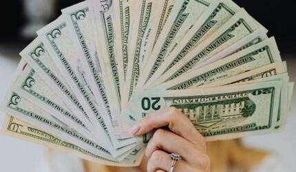 Lady holding a fan of money