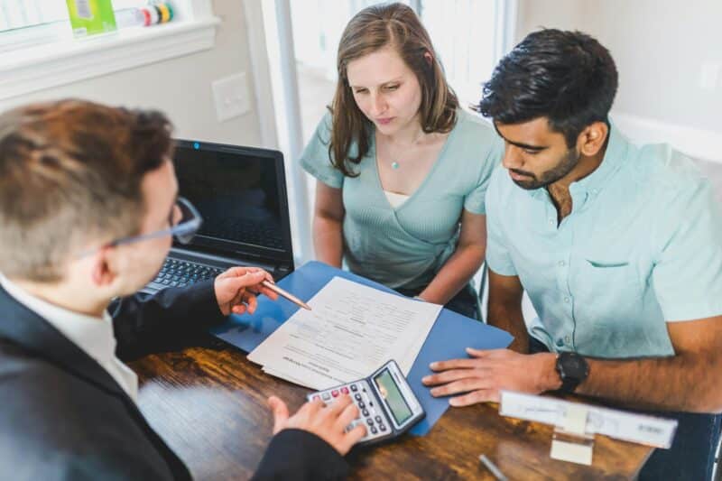 young couple talking to a lender about financing a home loan